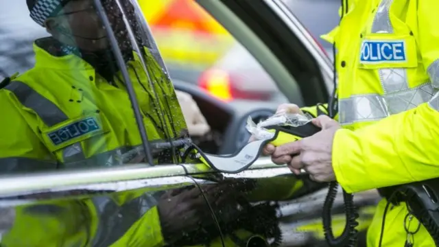 Breath test being carried out