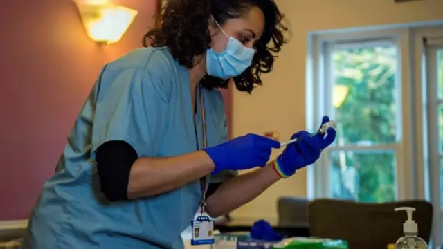 Nurse in care home prepares vaccine