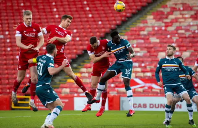 Tommie Hoban heads home the opener at Pittodrie