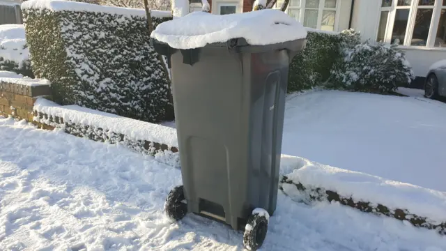 Bin covered in snow