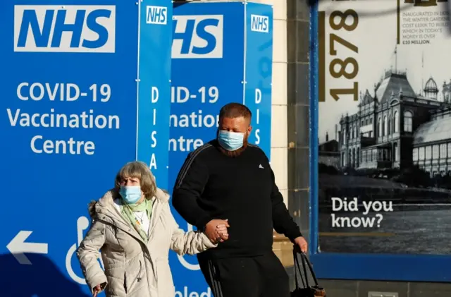 Two people outside a new vaccination centre in Blackpool, Lancashire