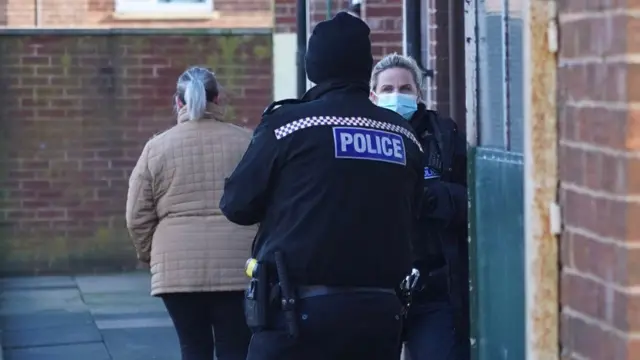 Police officers guard the flat