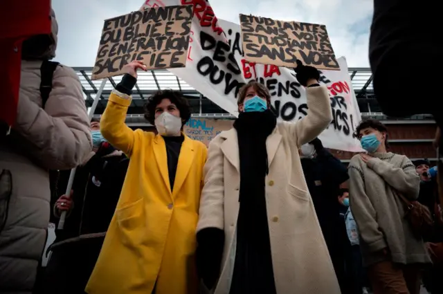 People hold placards during a demonstration part of a nationwide day of protest against French government Education policy