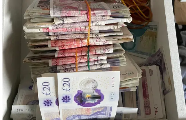 A pile of £10, £20 and £50 notes that have been seized.