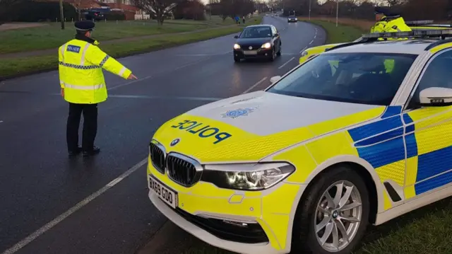 A police officer pulls over a car