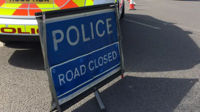 Police road closed sign