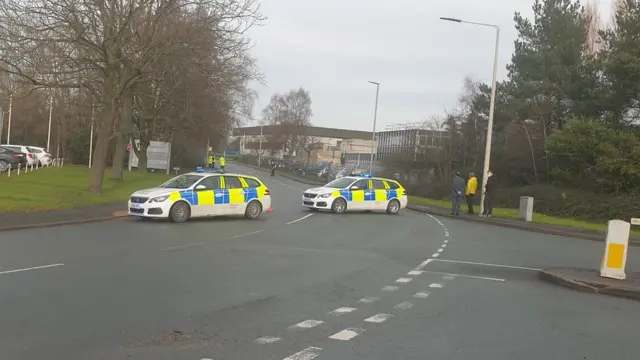 Police vehicles at the plant