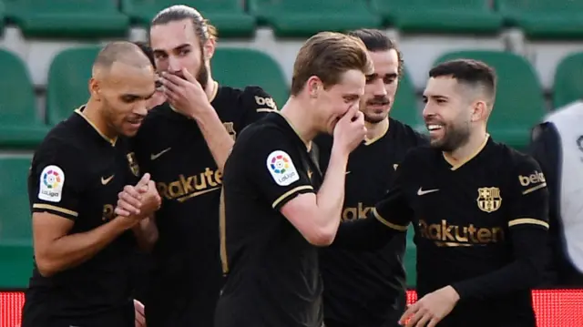 Barcelona players celebrate scoring at Elche