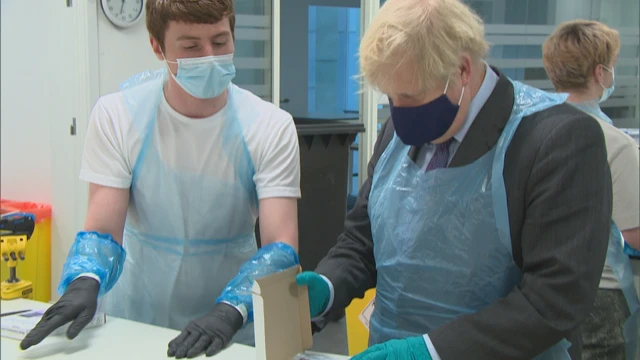 Boris Johnson unpacks boxes