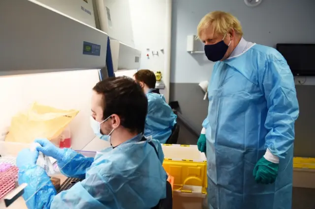 Prime Minister Boris Johnson (right) is shown the Lighthouse Laboratory