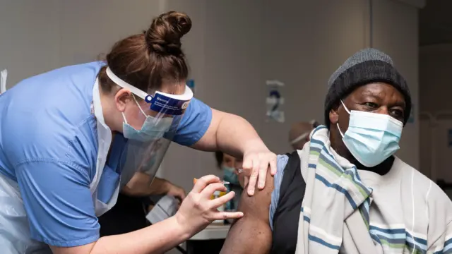 Man receiving a coronavirus vaccination