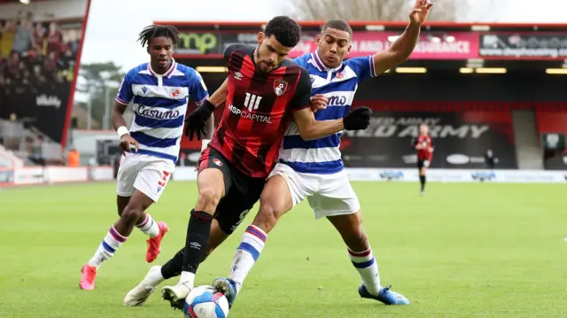 Bournemouth's Dominic Solanke tries to skip away from Andy Rinomhota