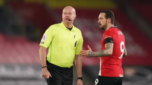 Danny Ings talks to referee Lee Mason