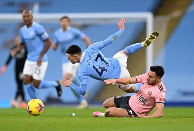 Phil Foden tackled