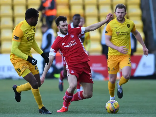 Connor McLennan (centre) in action with Efe Ambrose and Nicky Devlin of Livingston