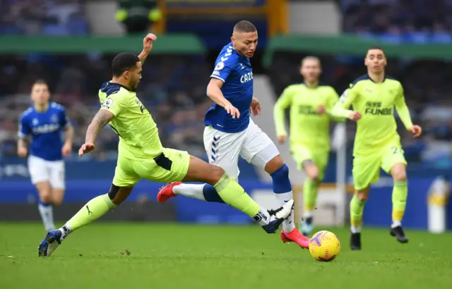 Richarlison challenged by Jamaal Lascelles