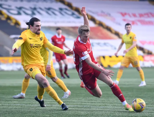 Ciaron Brown of Livingston in action with Aberdeen's Ross McCrorie