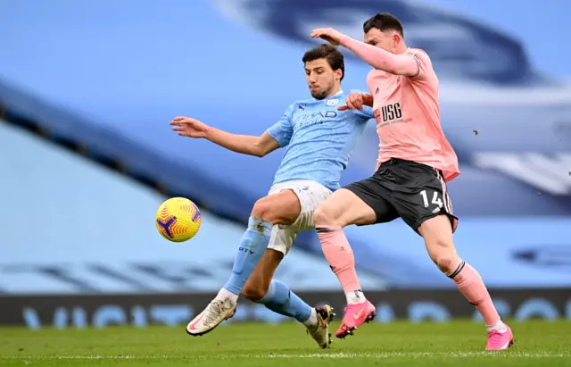 Ruben Dias challenges Oliver Burke