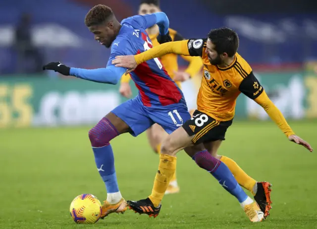 Wilf Zaha takes on Joao Moutinho