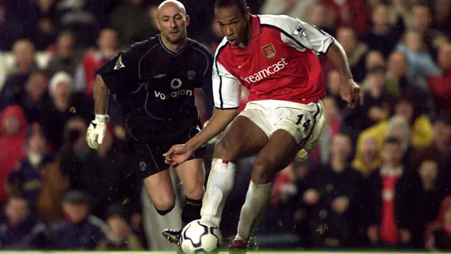 Thierry Henry of Arsenal beats Manchester United Keeper Fabien Barthez