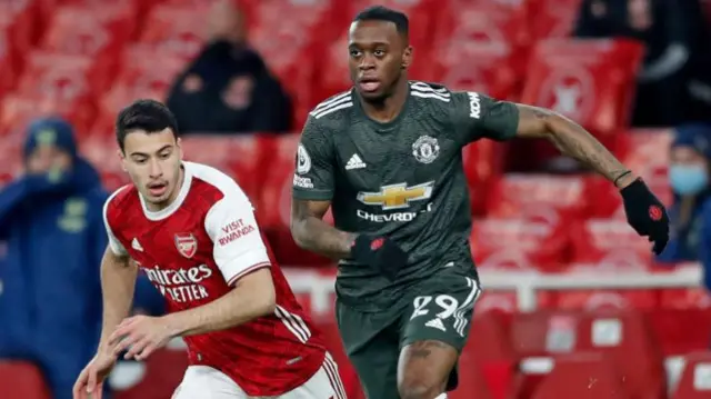 Manchester United's English defender Aaron Wan-Bissaka vies with Arsenal's Brazilian striker Gabriel Martinelli