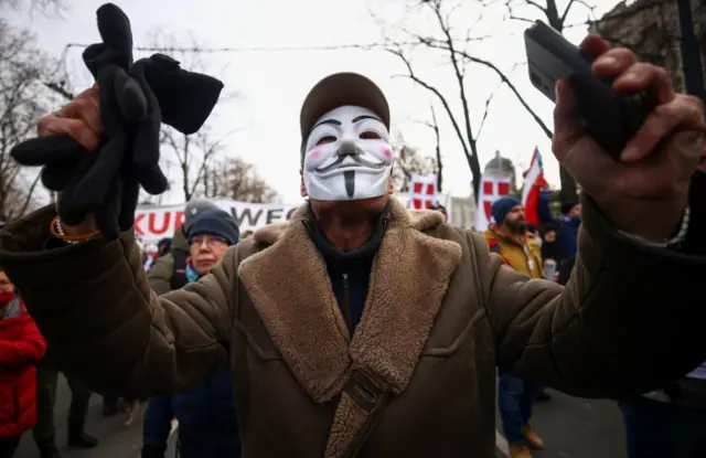 A man wears a mask at a protest in Vienna