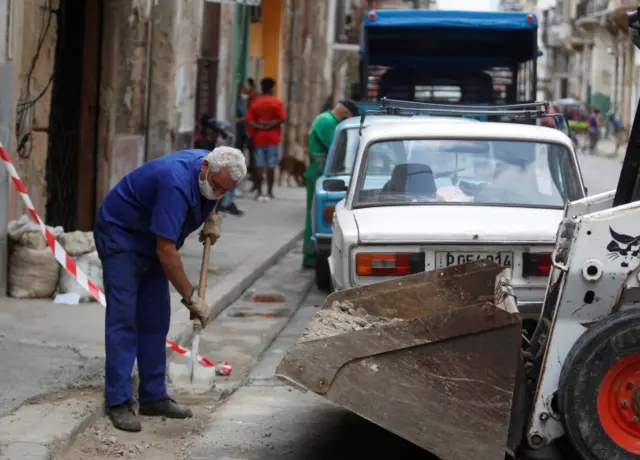 A man collects rubbish from a construction site, in Havana, Cuba, on 28 January 2021 (issued 29 January 2021).