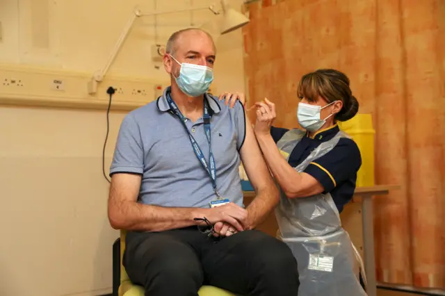 Prof Andrew Pollard, director of the Oxford Vaccine Group receives the jab