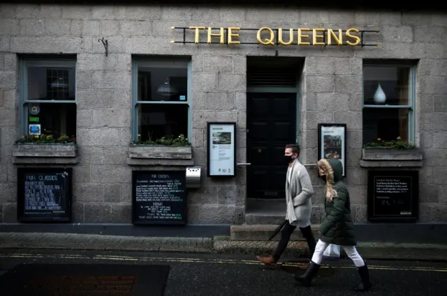 People walking past a pub in St Ives, Cornwall