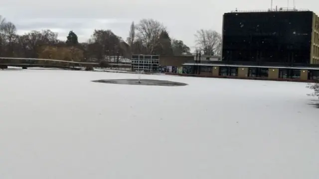 Lake at University of York frozen and covered in snow