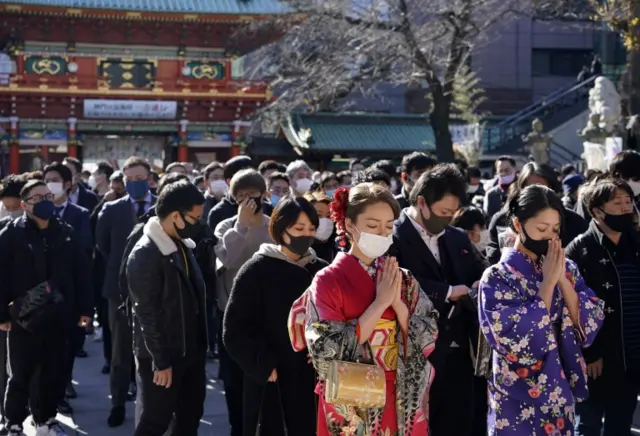 offer prayers for prosperity for their companies and the economy during the start of the New Year at the Kanda Myojin Shrine in Tokyo