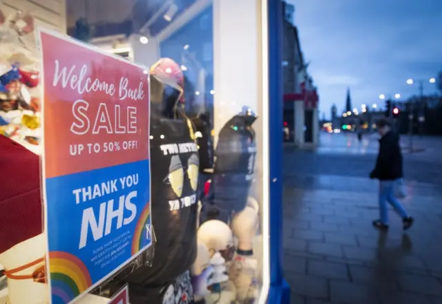 Signs in the window of a closed shop on Princes Street in Edinburgh, Scotland, where Covid-19 restrictions were increased for three weeks from Boxing Day