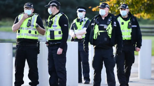 A group of police wearing face masks