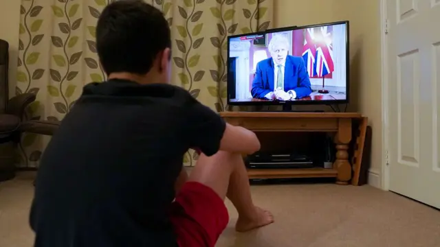 Boy watching Boris Johnson speech