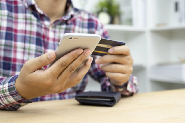 Man with phone and credit card