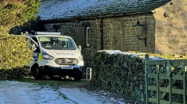 Police vehicle at home of deceased couple