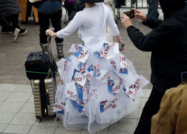 One Trump fan wears a dress made of "stolen ballots"