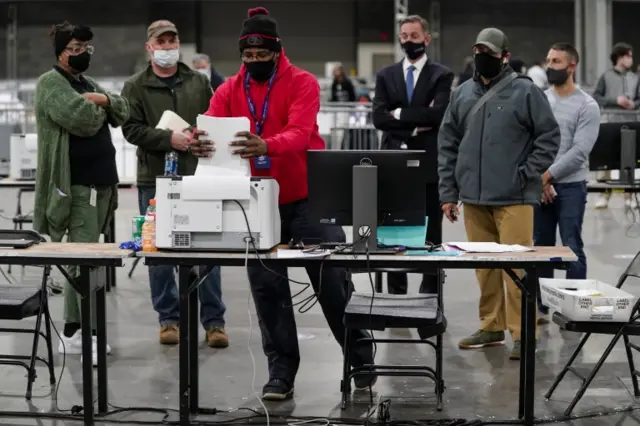 A man processes ballots