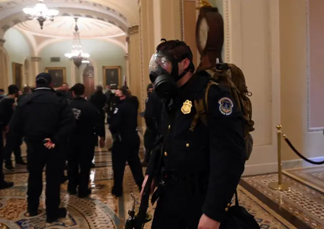 Trump supporters stand on the U.S. Capitol Police armored vehicle as others take over the steps of the Capitol on Wednesday, Jan. 6, 2021, as the Congress works to certify the electoral college votes