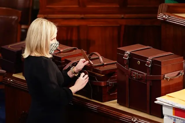 Congressional staff open the boxes containing electoral certificates during a joint session of Congress, 6 January