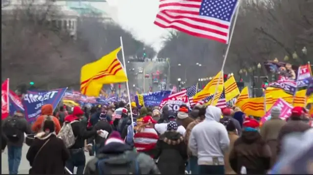 Protesters carrying US, Trump and South Vietnam flags march in Washington DC