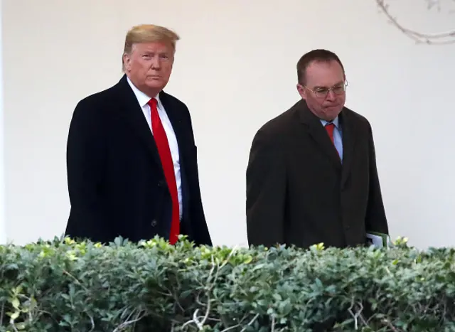 President Donald Trump walks with Mick Mulvaney (file photo)