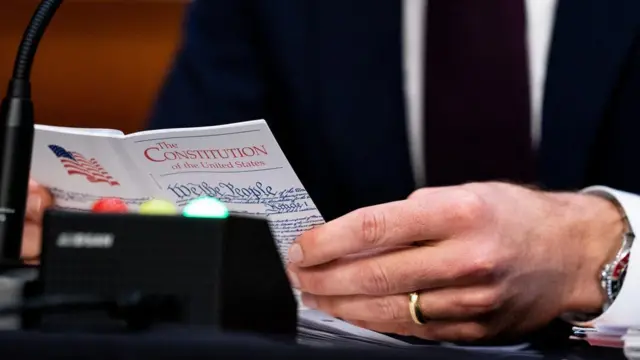 A man holds a copy of the US constitution