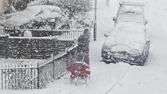 A postal worker in the snow