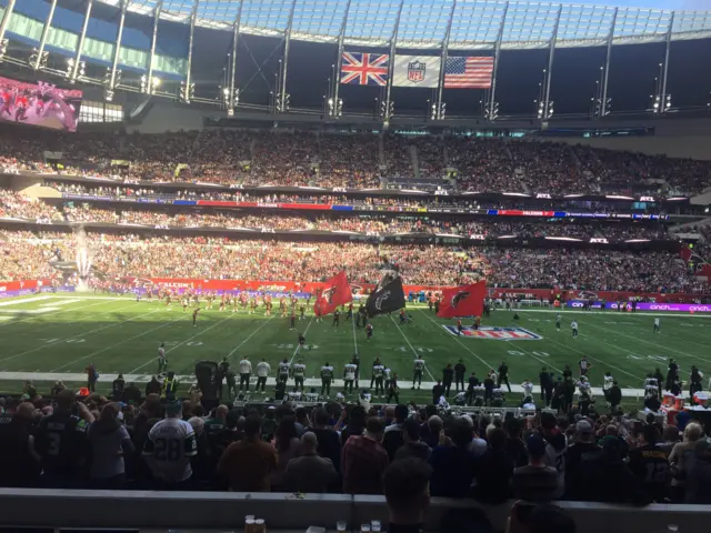 The Atlanta Falcons enter the field at the Tottenham Hotspur stadium