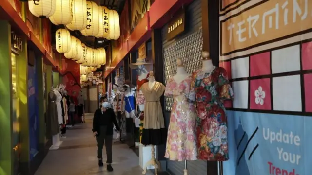 A woman walks past stores at a shopping centre which is usually busy with foreign tourists in Bangkok, Thailand, on 11 October 2021.