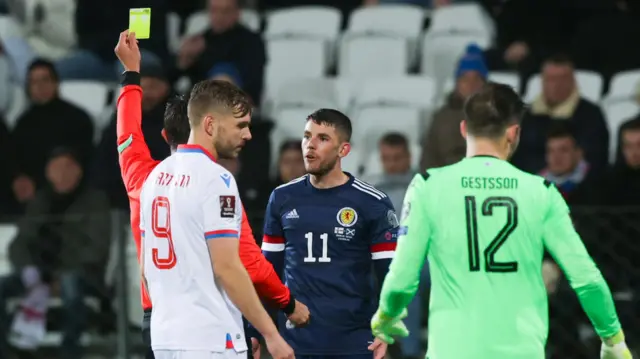 Ryan Christie is shown a yellow card for a poor challenge
