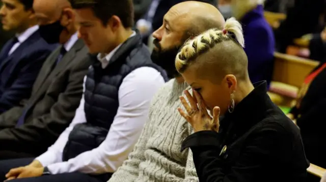 A woman is emotional at the mass for Sir David Amess