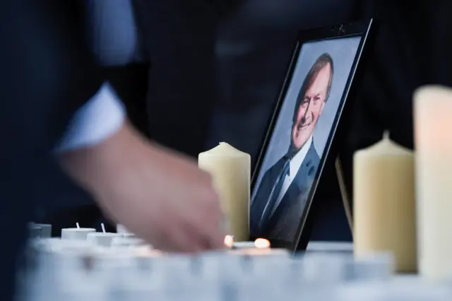 Candles and picture of David Amess