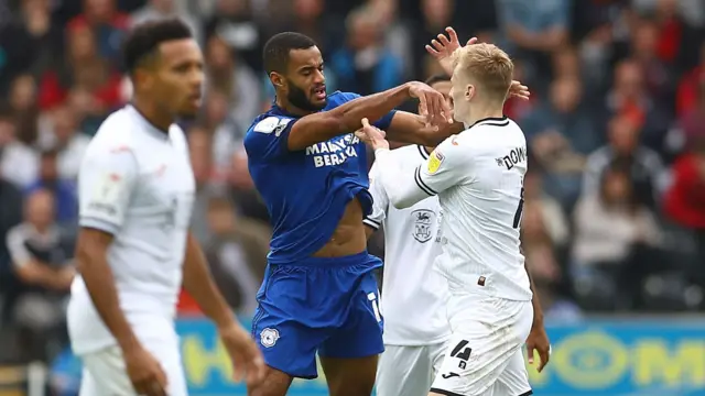 Curtis Nelson of Cardiff City and Flynn Downes of Swansea City clash off the ball